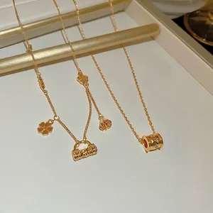 18k gold plated necklace set with floral handbag pendant and zircon cylinder charm