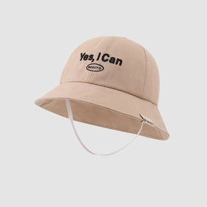 Detail of embroidered 'Yes, I Can' lettering on a beige cotton kids bucket hat
