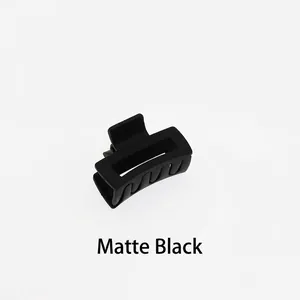Close-up of a mini 4cm matte black square hollow hair claw clip with geometric design