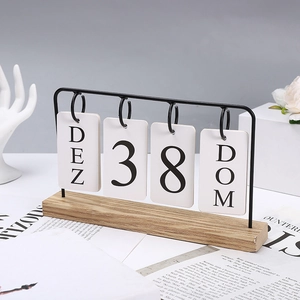 Detail of Nordic wooden desk calendar with black metal frame and white date cards