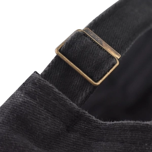 Detail of adjustable metal buckle and washed cotton fabric on black baseball cap