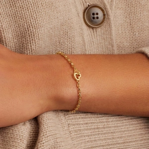 Minimalist 18k gold plated stainless steel heart link chain bracelet worn by a model