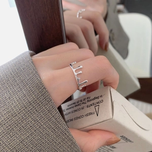 Detailed close-up of 925 silver dripping lava ring on hand with elegant packaging