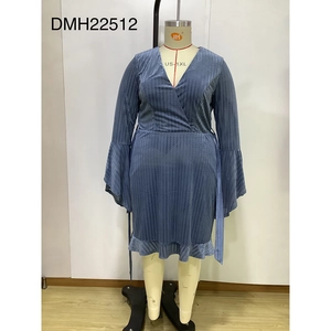 Close-up of blue V-neck dress featuring wavy textured fabric and ruffled hemline