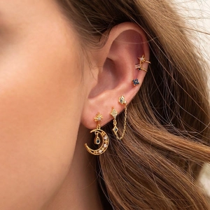 Golden moon and blue zircon earring set featuring star studs and floral ear cuffs