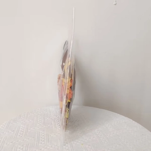 Detail view of harvest season decorative doll garland packaged in a clear protective polybag