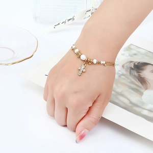 Elegant gold-plated double-layer pearl bracelet with a sparkling crystal cross pendant