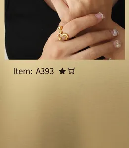 Detail of minimalist wave pattern open gold ring worn on finger with ball accents