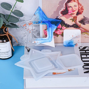 Detailed view of star-shaped silicone mold with blue resin photo frame craft samples