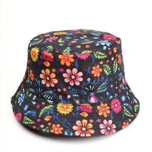 Detail shot of the floral bucket hat featuring vibrant orange and pink flower patterns