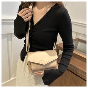 Close-up of beige crossbody bag with gold Fashion & Bags lettering and wide strap