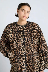Detailed view of women's leopard print quilted jacket with button closure and round neck