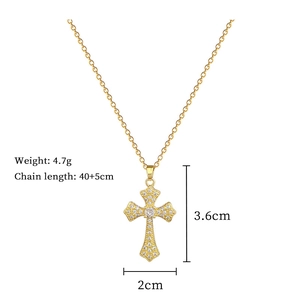 Detail view of gold cross pendant with cubic zirconia and size dimensions info