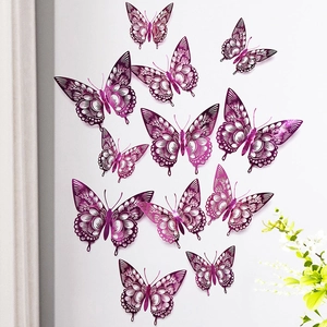 Detailed view of 3D metallic purple cutout butterflies with delicate hollow patterns on wall