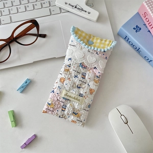 Close-up of quilted fabric glasses pouch with cute bear pattern and heart button detail