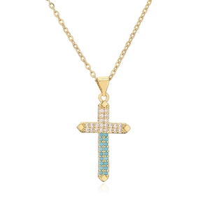 Gold cross necklace with turquoise and cubic zirconia stones on white background