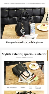 Detail view of large capacity black tote bag with interior storage and phone size guide