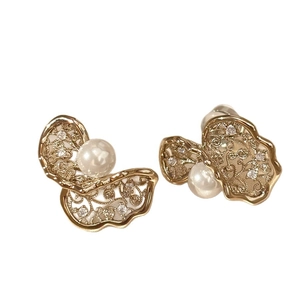 Elegant gold hollow earrings with pearls and cubic zirconia in a vintage design