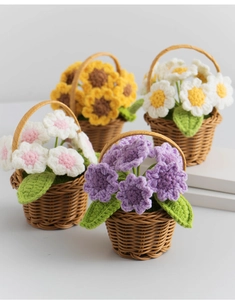 Detail of four handmade crochet flower baskets with sunflowers and daisies on grey surface