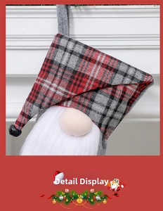 Close-up of Christmas gnome ornament with red plaid hat, white beard and small black bell