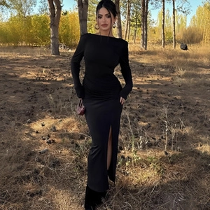 Detail of slim fit black long sleeve dress featuring an elegant side slit design