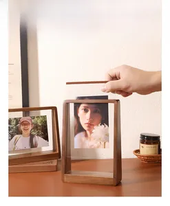 Close-up showing the pull-out design for easy photo exchange in a walnut wood frame
