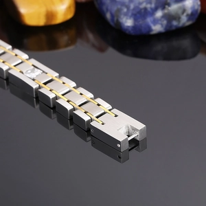 Macro side view of two-tone brushed stainless steel bracelet with square cubic zirconia