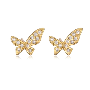 Macro detail of 18K gold plated bow earrings encrusted with sparkling clear diamonds