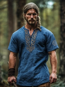 Detailed view of Celtic knot embroidery on a blue Viking-style linen shirt for men