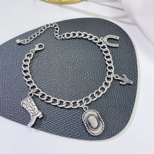 Bohemian silver cowboy charm bracelet featuring vintage boot, hat and horseshoe charms