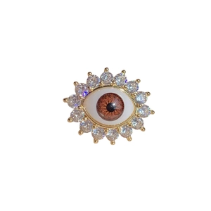 Evil eye open ring with gold metal sunburst setting and sparkling clear zircon stones