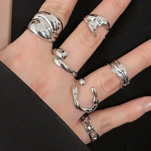 Close-up of liquid metal style silver resin rings with molten texture and diamond accents