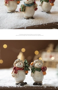 Detail of hand-painted resin snowman ornaments with festive red and green scarves