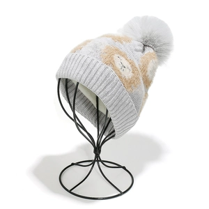 Détail du bonnet d'hiver en tricot gris pour enfants avec pompon et doublure chaude
