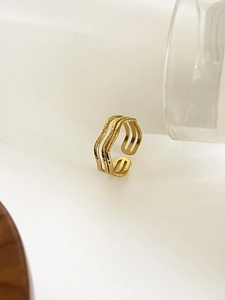 Detail of gold multilayer wavy ring with irregular liquid lines and adjustable opening