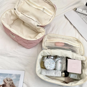 Internal view of quilted makeup bags with mesh zip pockets for brush storage