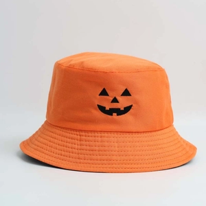 Detail of orange Halloween bucket hat featuring a black embroidered pumpkin face