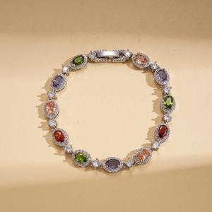 Detailed close-up of oval multi-colored gemstone bracelet with halo zircon settings