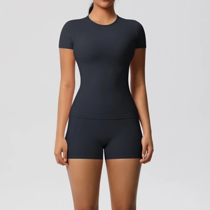 Front view detail of a black slim fit two-piece yoga set with short sleeves and high-stretch shorts