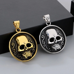 Macro detail of gothic skull pendants in gold and silver finish with polished surface