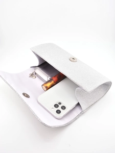 Silver glitter evening clutch showing internal capacity for phone, lipstick and keys