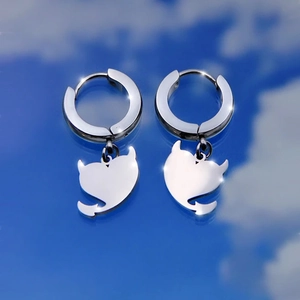 Polished silver stainless steel hoop earrings with cute devil heart charms on blue sky