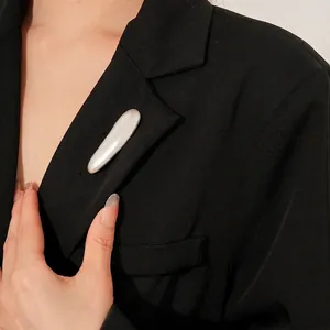Minimalist silver bar metal brooch shown on black blazer lapel with elegant polished finish