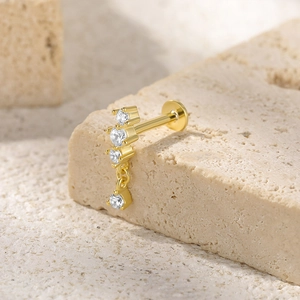 Detailed macro view of S925 silver butterfly ear stud with gold finish and zircon stones