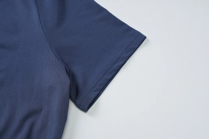 Detailed macro view of the double-stitched sleeve cuff on this navy blue knit dress
