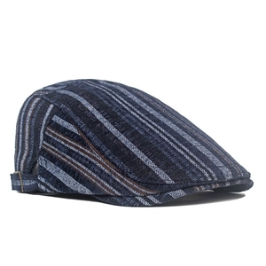 Detail view of striped navy beret featuring adjustable metal buckle and textured fabric
