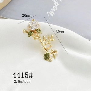 Detailed size view of a 20x39mm white enamel rose and green leaf alloy charm