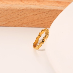 Modern minimalist gold irregular wavy ring with polished titanium steel on wood background