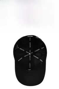 Detail of breathable interior lining and adjustable metal buckle on black baseball cap