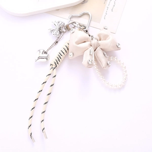 Bowknot phone charm with rhinestones and pearls on braided rope for bags and keys